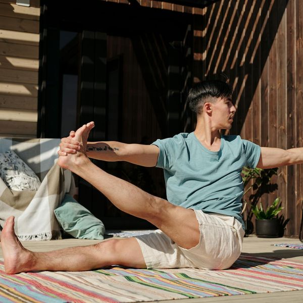 Man sitting in a meditative pose after a workout, showing focus and calm.